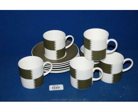 A Susie Cooper 'Heraldry Green' set of six Coffee Cans and saucers, one cup and saucer a/f, and the original box also a/f.