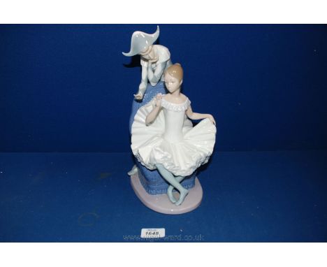 A large Nao figure of a Jester standing by a Ballerina, one finger missing.