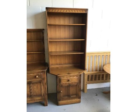 Ercol elm two height bookcase with three opened shelves above single drawer and cupboard below H196.5cm W80cm D50cm