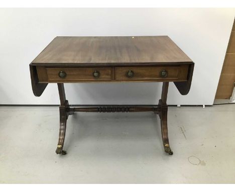 Regency style mahogany sofa table, hinged crossbanded top with reeded edge and two frieze drawers on standard ends and splaye