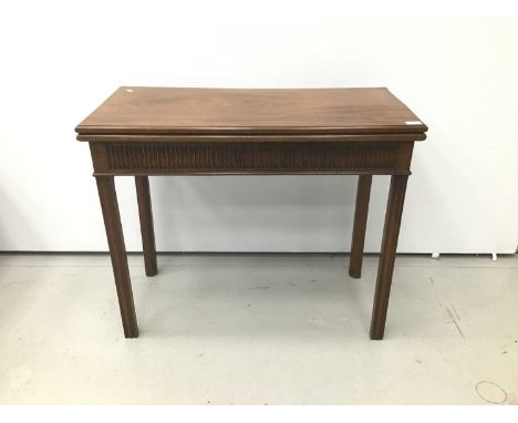 George III mahogany card table with rectangular fold-over revolving top, fluted frieze on moulded square chamfered legs. 91cm