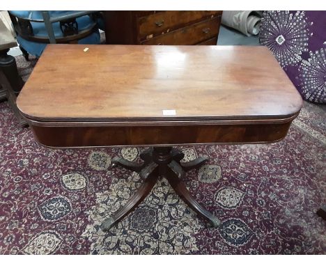 Regency mahogany card table with fold over top on carved and turned column and four splayed legs, 91cm wideProvenance: Estate