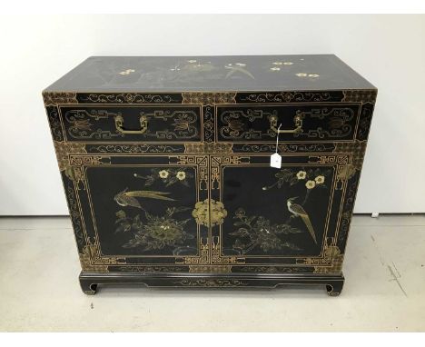 Chinese black lacquered cupboard with decorative chinoiserie foliate and bird gilded decoration, two drawers and cupboards be