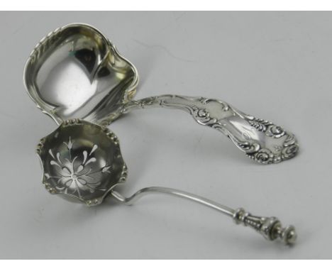 A silver sugar sifter spoon, together with an unusual silver ladle, having embossed decoration. 