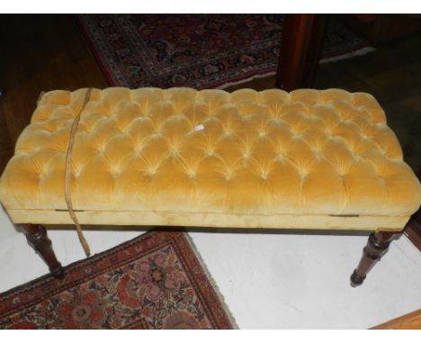 A 20th century mahogany framed piano stool, the hinged lid with light brown button back upholstery. H.52cm W.114cm D.46cm