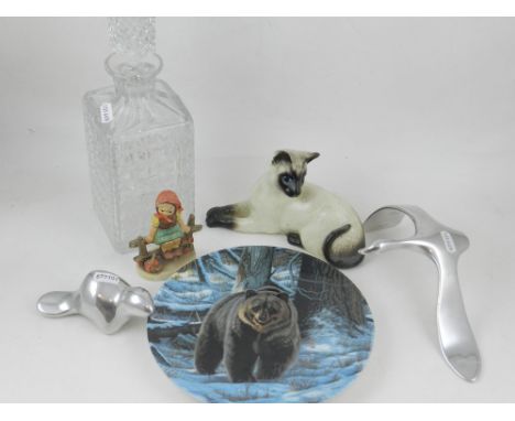 A moulded glass decanter, together with stylised aluminum  models of an otter and a swan, a Royal Doulton study of a cat, a G