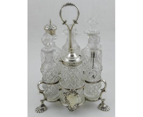 H. Y. Wilkinson & Co., Sheffield. A 19th century silver cruet set and stand, includes original glass containers, raised on sh