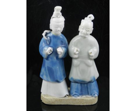 Two early 18th century Chinese Kangxi period celadon glazed figures, raised on biscuit clay plinth. H.15.5cm (including plint