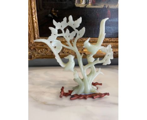 A Chinese (?) Jade Carving of Birds and Foilage on an associated wooden stand.  Dimensions: 9 in (H) x 7 in (W)