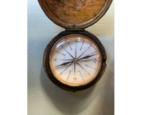 From the Collection of Admiral Grindall and by descent.A late 18th Century compass with hand-painted dial. In a red leather c