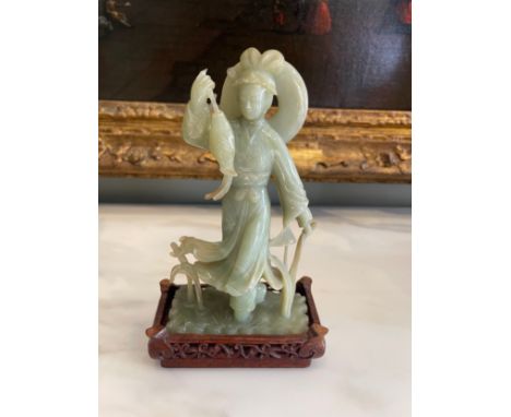 A Chinese Carved Jade Figure, With A Fish, on an associated wooden stand. Dimensions: 9 in (H) x 5 in (W)