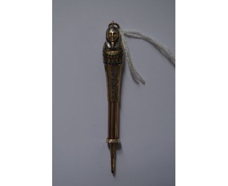 An Egyptian Revival figural silver and enamel propelling pencil. 