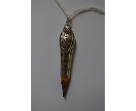 An Egyptian Revival figural white metal and enamel pencil holder. 