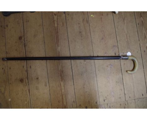 A horn handled and silver mounted ebonized walking stick. 