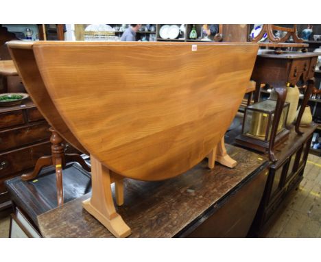 A vintage Ercol elm drop leaf table, 128cm wide. 