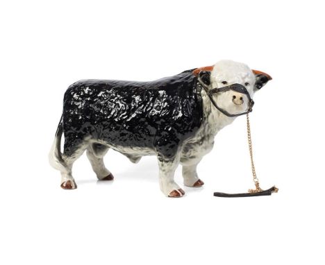 A large mid 20th century butchers shop advertising figure of a Hereford Bull, unusual darker colour, with horns, 42cm long, u