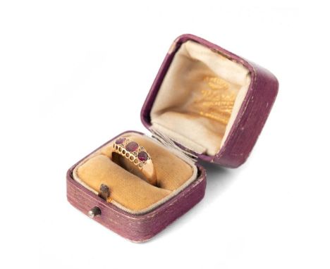 18ct gold three stone garnet ring with diamond highlights, in period box, size Q/R, 2.5g.