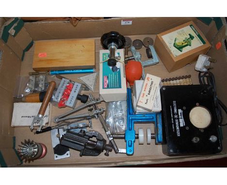 A box of assorted watch repairer's workshop tools to include vices, clamps, Horotec B-set, electronic demagnitiser etc