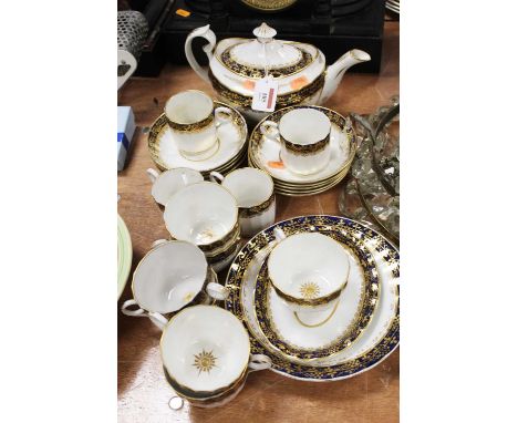 An early 19th century English porcelain part tea and coffee service,  fluted white ground bodies with a cobalt blue border wi