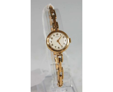 A 9ct yellow gold Rotary manual wind wristwatch, having round cream Arabic dial and integral spring link bracelet, case dia.2