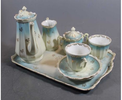 A 20th century continental porcelain tete-a-tete decorated in light blue and gilt 