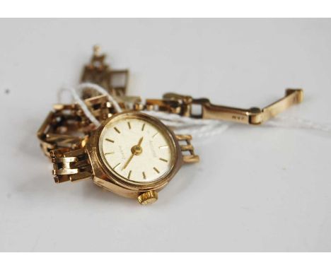 A yellow metal Accurist quartz watch, having round champagne baton dial and fitted to a three bargate link bracelet, with lad