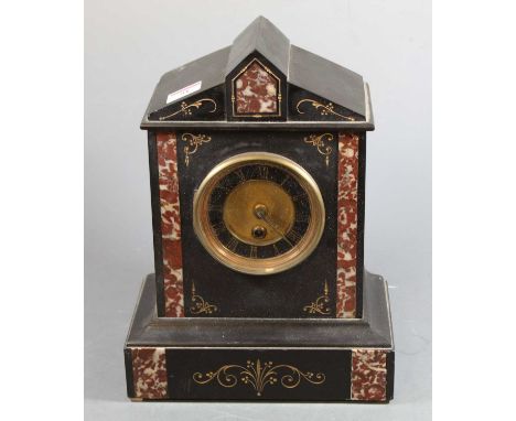 A late Victorian black slate and rouge marble mantel clock having a black enamel dial with gilt Roman numerals, 8 day cylinde