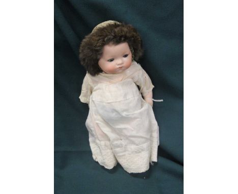 An Armand Marseille German bisque head baby doll, having rolling blue eyes and closed mouth, bent-limbed composition body, ma