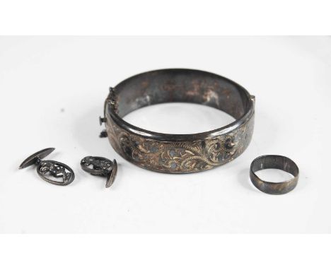 A Victorian style silver and engraved hinged bangle; together with a silver wedding band; and a pair of sterling silver cuffl