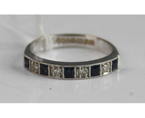 An 18ct white gold, sapphire and diamond half hoop eternity ring, comprising five square cut sapphires alternating with four 