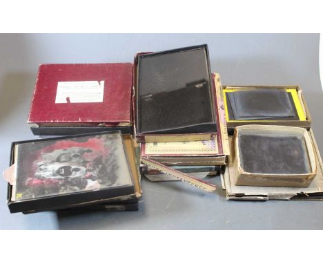 A mid-20th century photograph album and contents, mainly being family scenes; together with various French magic lantern slid