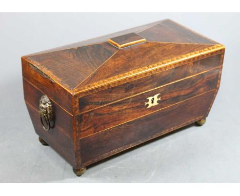 A Regency rosewood and boxwood chevron banded tea caddy, of sarcophagus form with ivory inlaid escutcheon, flanked by twin li