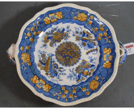 An early 19th century Spode warming dish of shaped circular form having twin handles, transfer printed with various urns and 