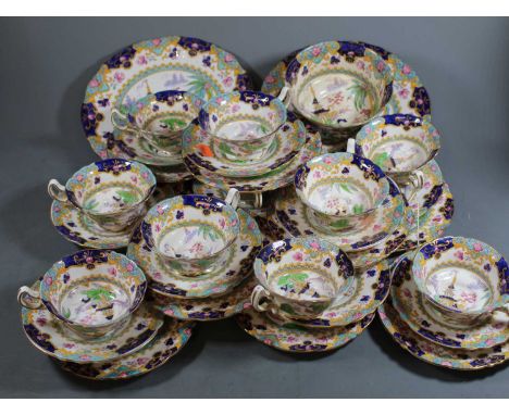 An early 20th century Royal Doulton part tea service in the Pagoda pattern  No. E3741, to include 10 teacups, 11 saucers, 10 