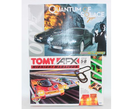 A Micro-Scalextric Quantum of Solace 007 slot racing set, together with a Tomy AFX Midnight Marathon slot racing gift set, bo