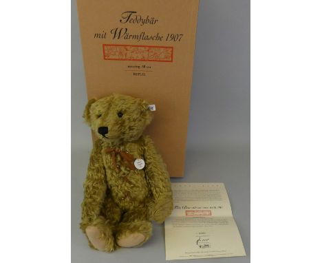 A Steiff limited edition hot water bottle bear, 1907, No. 0983/3000, EAN 406621, 50cm tall, with brass coloured mohair, his t