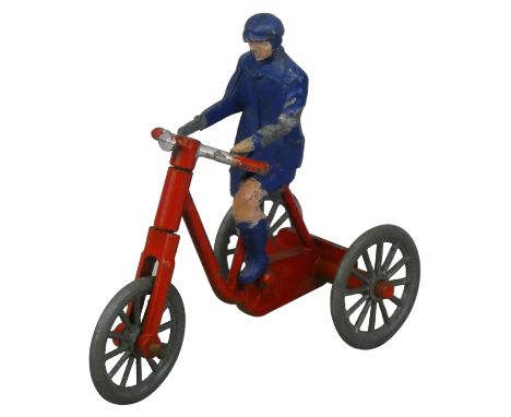 Morestone - A vintage model of a boy on a tricycle, with steering and detachable rider, unpainted metal wheels on nailhead an