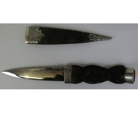 A Scottish silver mounted Skean Dhu, Birmingham 1928, the carved oak handle with a citrine glass finial, leather scabbard, le
