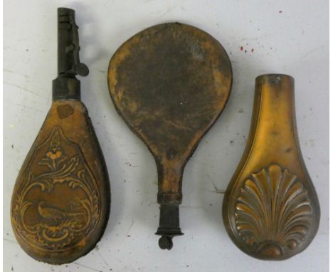 A 19th century embossed leather and metal powder flask, decorated with a pheasant, an embossed copper example, lacking intern