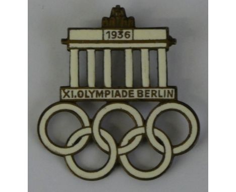 A 1936 white enamel Berlin Olympics pin badge, "XI Olympiade Berlin" to the front, "Paulmann Crone Lüdenscheid" to the revers