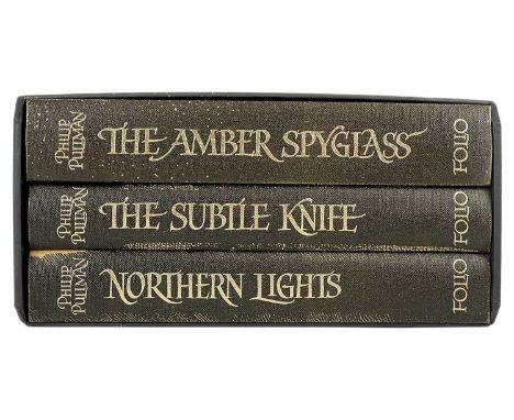 The Folio Society His Dark Materials by Philip Pullman Three volumes fine, light scratches to card slip, 2008. (3)