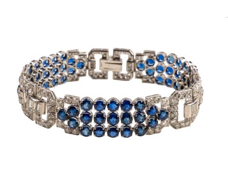 AN ART DECO SAPPHIRE AND DIAMOND BRACELET (2)With three sections of old, baguette and round brilliant cut diamonds in bright 