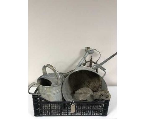 A basket of two galvanised watering cans, bucket, block and tackle, tilly lamp etc 