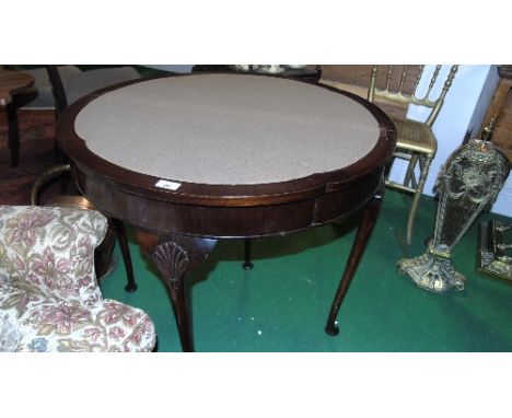 An Early 20th Century Mahogany Demi Lune Fold-over Card Table, on slender pad supports with beige interior.