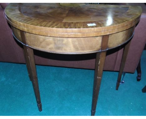 A 20th Century Satin Mahogany Sunburst Fold Over Card Table, standing on square tapered legs.
