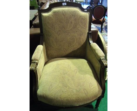 An Armchair, Possibly French, with upholstered seat, back and arm pads  with moulded outline scolled arms raised on turned an