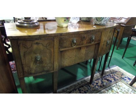 A Regency Mahogany and Inlaid Bow Fronted Sideboard, bordered with ebonised lines, fitted with a central frieze and recessed 