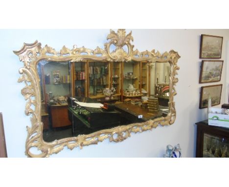 A Wonderful 20th Century Timber Gilt Chinese Chippendale Wall Mirror, with a very highly carved pierced surround. 51 x 34ins.