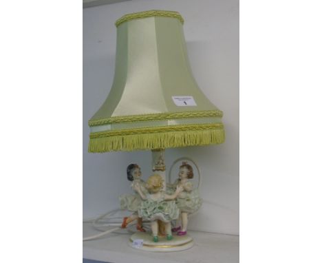 An Irish Dresden 'Ring a Ring a Rosie' Emerald Collection Table Lamp.