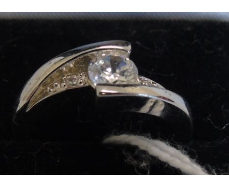 A Silver and Gem Set Crossover Ring. Size K
